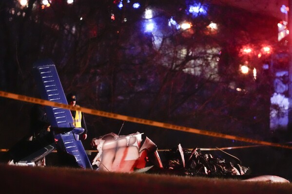 Emergency officials work the scene of a fatal small plane crash alongside Interstate 40 near mile marker 202, Monday, March 4, 2024, in Nashville, Tenn. (AP Photo/George Walker IV)