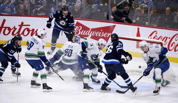 Connor's hat trick powers Jets' 7-4 win over Canucks