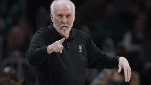 FILE - San Antonio Spurs coach Gregg Popovich points from the bench during the second half of the team's NBA basketball game against the Boston Celtics, March 26, 2023, in Boston.  Popovich apparently has no plans to leave the Spurs anytime soon.  The NBA's all-time winningest coach has signed a five-year contract to remain coach and president of the team, the Spurs announced on Saturday, July 8.  (AP Photo/Steven Senne, File)