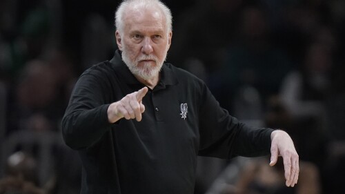 FILE - San Antonio Spurs coach Gregg Popovich points from the bench are during the second half of the team's NBA basketball game against the Boston Celtics, March 26, 2023, in Boston. Popovich evidently doesn’t plan to leave the Spurs anytime soon. The NBA’s all-time winningest coach has signed a five-year contract to remain coach and president of the team, the Spurs announced Saturday, July 8. (AP Photo/Steven Senne, File)