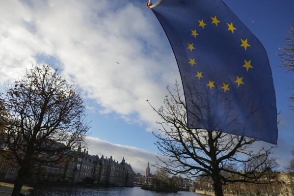 A European Union flag flies outside parliament building, rear left, one day after the far-right Party for Freedom of leader Geert Wilders won the most votes in a general election, in The Hague, Netherlands, Thursday Nov. 23, 2023. (AP Photo/Peter Dejong, File)
