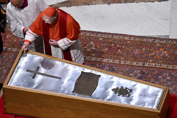 Cardianal Camerlengo Kevin Joseph Farrel seals the zinc cover of the casket containing the body of late Pope Francis in St. Peter's Basilica at the Vatican Friday, April 25, 2025. (Vatican Media via AP)