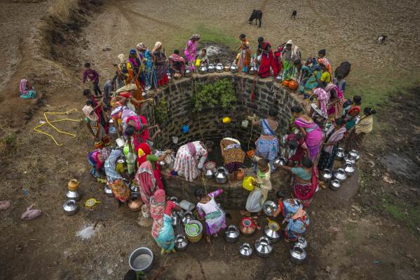 Villagers gather around a well to draw water in Telamwadi, northeast of Mumbai, India, Saturday, May 6, 2023. Collecting water from outside wells is a common task in this rural area, which has seen increasing protests as more river water from dams is diverted to urban areas. (AP Photo/Dar Yasin)