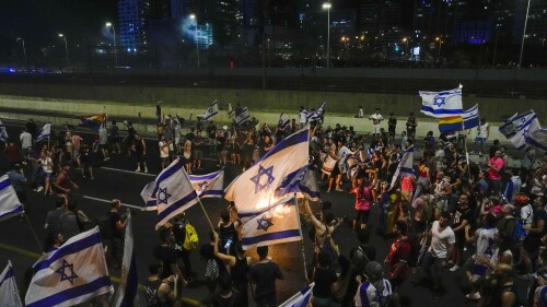 Israelis block a highway as they protest against plans by Prime Minister Benjamin Netanyahu's government to overhaul the judicial system, in Tel Aviv, Israel, Tuesday, July 18, 2023. (AP Photo/Ariel Schalit)