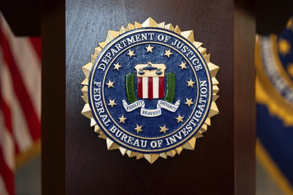 An FBI seal is displayed on a podium before a news conference at the field office in Portland, Ore., Jan. 16, 2025. (AP Photo/Jenny Kane, File)