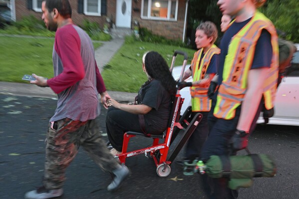 An injured tornado victim is transported in Gaithersburg, Md., Wednesday, June 5, 2024. Several people were hurt when a large tree collapsed on a house on Dogwood Drive. (Michael S. Williamson/The Washington Post via AP)
