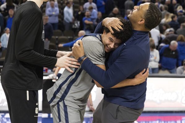 Butler's Landon Moore, center, hugs assistant coach Mike Pegues following their 99-98 win against Creighton during an NCAA college basketball game Friday, Feb. 2, 2024, in Omaha, Neb. (AP Photo/Rebecca S. Gratz)