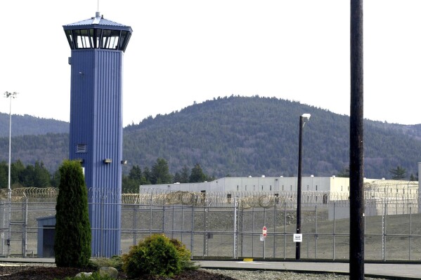 FILE - A tower stands at Pelican Bay State Prison outside of Crescent City, Calif. The Northern California prison was on generator power for a second week and inmates were issued masks to cope with unhealthy air after wildfires knocked out electricity and choked the remote region with smoke. (AP Photo/Rich Pedroncelli, File)