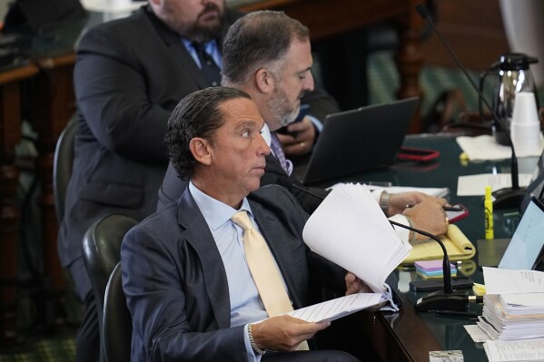 Defense attorney Tony Buzbee, front, listens to testimony during the impeachment trial for Texas Attorney General Ken Paxton in the Senate Chamber at the Texas Capitol, Wednesday, Sept. 13, 2023, in Austin, Texas. (AP Photo/Eric Gay)