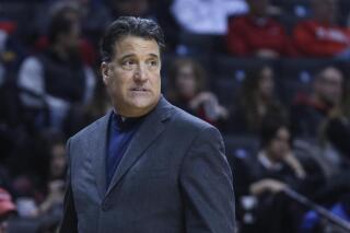 FILE - St. John's coach Steve Lavin walks along the sideline during the first half of the team's NCAA college basketball game against Tulane on Dec. 28, 2014, in New York. Lavin, the former coach at UCLA and St. John's, was hired Wednesday night, April 6, 2022, to take over the program at the University of San Diego. (AP Photo/John Minchillo, File)