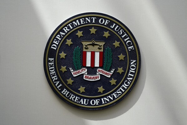 FILE - The FBI seal is pictured in Omaha, Neb., Aug. 10, 2022. A Utah man has been charged with threatening a Palestinian rights organization in Washington. The case was unsealed Monday, Nov. 20, 2023, as tensions rise in the U.S. from the devastating war between Israel and Hamas. (AP Photo/Charlie Neibergall, File)