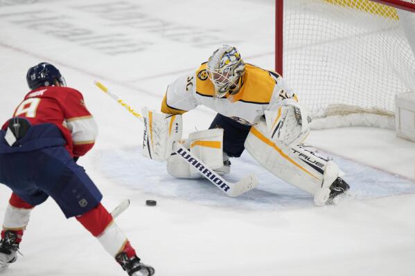 Florida Panthers left wing Matthew Tkachuk (19) attempts a shot at Nashville Predators goaltender Kevin Lankinen (32) during the second period of an NHL hockey game, Thursday, March 2, 2023, in Sunrise, Fla. (AP Photo/Wilfredo Lee)