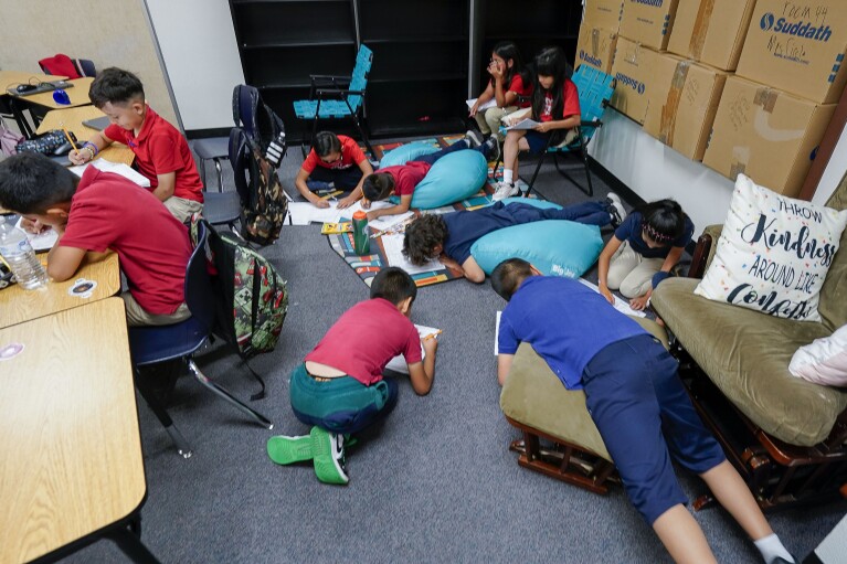 Students works on their memory books during the last week of classes at Frye Elementary School in Chandler, Arizona Tuesday, May 23, 2023.(AP Photo/Darryl Webb)
