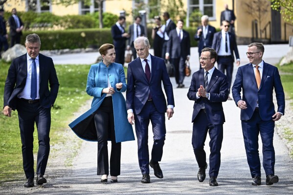 Sweden's Prime Minister Ulf Kristersson, second from right, welcomes the prime ministers of the Nordic countries, from left, Iceland's Bjarni Benediktsson, Denmark's Mette Frederiksen, Norway's Jonas Gahr Støre and Finland's Petteri Orpo, at Skeppsholmen in Stockholm, Sweden, Monday, May 13, 2024, ahead of a two-day Nordic Prime Minister's meeting, on security and competitiveness. (Pontus Lundahl/TT News Agency via AP)