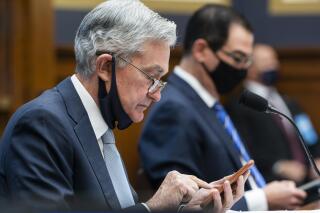 FILE - In this Dec. 2, 2020 file photo, Federal Reserve Chair Jerome Powell, left, arrives to testify before a House Financial Services Committee hearing on Capitol Hill in Washington. Powell says, Friday, June 4, 2021, the U.S. central bank is studying how climate change might affect banks. But the Fed doesn't see itself as getting involved in how to fight climate change. (Jim Lo Scalzo/Pool via AP)
