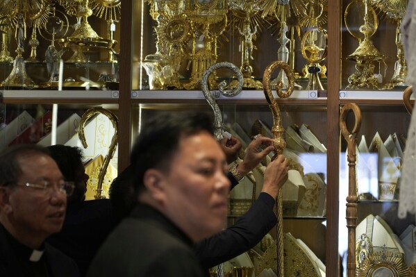 Priests visit the shop of Italian tailor Raniero Mancinelli, in Rome, Wednesday, April 30, 2025. (AP Photo/Gregorio Borgia)