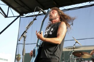
              FILE - In this Aug. 26, 2018 file photo, Dave Grohl of the Foo Fighters performs at the Cal Jam 18 Pop-Up Event at the Hollywood Palladium in Los Angeles.  Grohl doesn’t want firefighters battling the California wildfires to go hungry. He served his Backbeat Barbeque at Fire Station 68 in Calabasas on Monday, Nov. 12, 2018.   Firefighters, who have been battling the Woolsey fire, thanked Grohl on Instagram.   (Photo by Willy Sanjuan/Invision/AP, File)
            