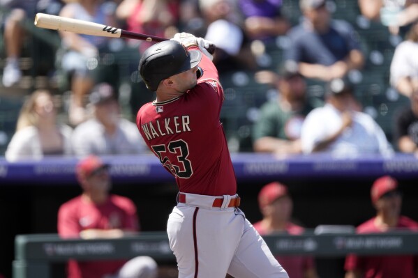 Arizona Diamondbacks' Christian Walker follows the flight of his two-run home run off of Colorado Rockies starting pitcher Austin Gomber in the first inning of a baseball game Wednesday, Aug. 16, 2023, in Denver. (AP Photo/David Zalubowski)