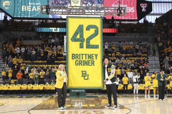 Former Baylor University legend and WNBA star Brittney Griner, right, looks on with Baylor head coach Nicki Collen, left, during her No. 42 jersey retirement ceremony before an NCAA college basketball game against Texas Tech, Sunday, Feb. 18, 2024, in Waco, Texas. (Rod Aydelotte/Waco Tribune-Herald via AP)