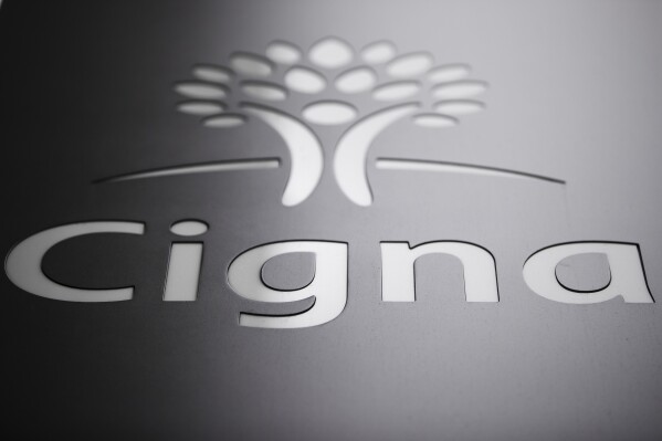 FILE - The Cigna Corp., logo is displayed at the headquarters of the health insurer, Nov. 26, 2018, in Philadelphia. The Cigna Group will sell its Medicare Advantage business to another insurer, Health Care Service Corp., for about $3.7 billion. Cigna said Wednesday, Jan. 31, 2024, the deal also includes a supplemental benefits business and Medicare prescription drug coverage. (AP Photo/Matt Rourke, File)