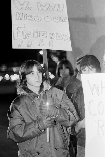 FILE - In this Dec. 4, 1979 file photo, a young man shields his candle from the wind during a memorial service for those killed during a stampede at a rock concert by the British rock band The Who at Cincinnati riverfront coliseum in Cincinnati, Ohio. (AP Photo/Brian Horton, File)