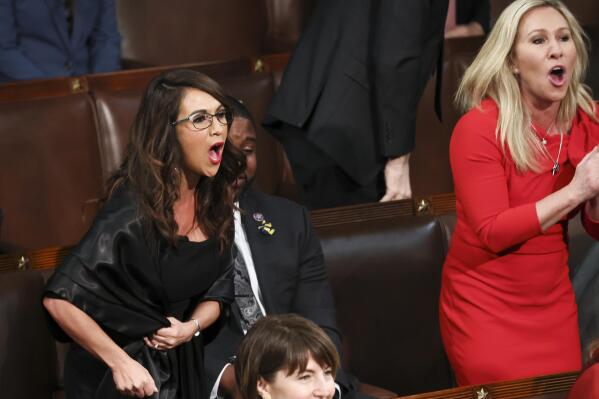 Rep. Lauren Boebert, R-Colo., left, and Rep. Marjorie Taylor Greene, R-Ga., right, scream "Build the Wall" as President Joe Biden delivers his first State of the Union address to a joint session of Congress at the Capitol, Tuesday, March 1, 2022, in Washington. (Evelyn Hockstein/Pool via AP)
