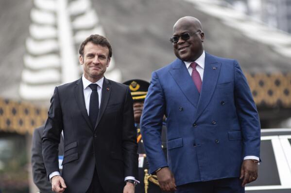 French President Emmanuel Macron, left, is greeted by Democratic Republic of the Congo President Felix Tshisekedi in Kinshasa Saturday March 4, 2023. Macron, on the last leg of an ambitious Africa trip that took him to Gabon, Angola, the Republic of Congo and Congo, wants to roll out more ambitious economic policies, in a bid to boost France's waning influence in the continent (AP Photo/Samy Ntumba Shambuyi)