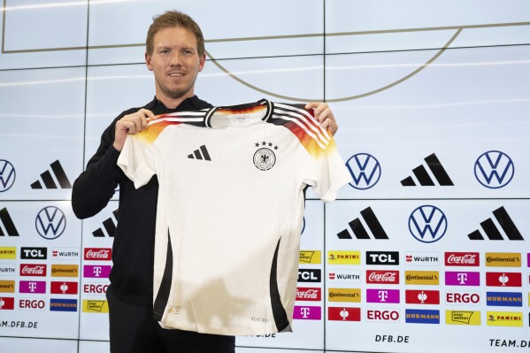 Germany coach Julian Nagelsmann presents the DFB team's new official European Championship jersey ahead of the international friendly matches against France and The Netherlands, during a press conference in Frankfurt, Germany, Thursday, March 14, 2024. (Boris Roessler/dpa via AP)