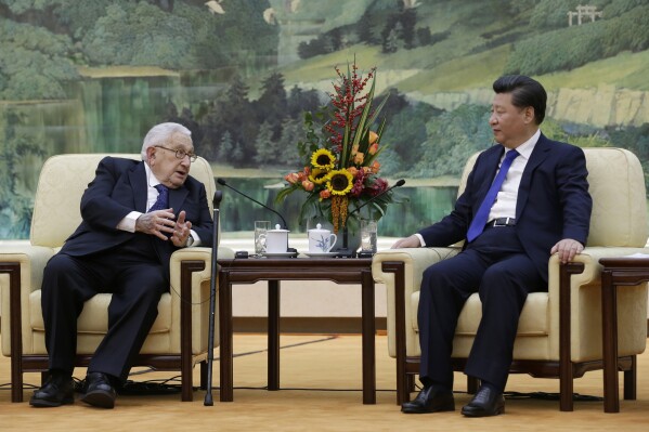 FILE - China's President Xi Jinping, right, listens to former U.S. Secretary of State Henry Kissinger, who led the China-U.S Track Two Dialogue, during a meeting at the Great Hall of the People in Beijing, China, Nov. 2, 2015. Kissinger, the diplomat with the thick glasses and gravelly voice who dominated foreign policy as the United States extricated itself from Vietnam and broke down barriers with China, died Wednesday, Nov. 29, 2023. He was 100. (Jason Lee/Pool Photo via AP, File)