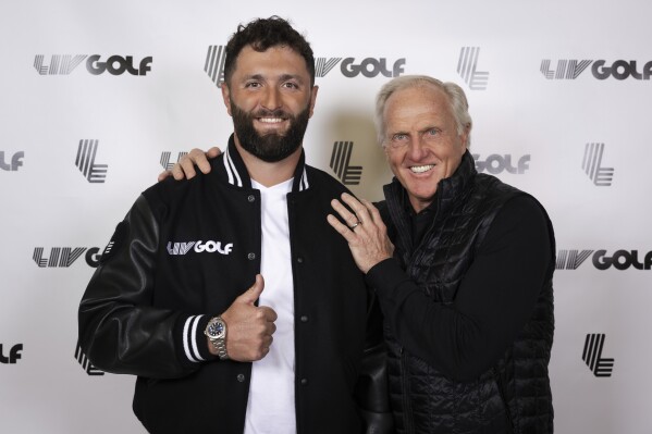 FILE - In a photo provided by LIV Golf, Jon Rahm, left, and LIV Golf Commissioner and CEO Greg Norman pose for a photo in New York on Thursday, Dec. 7, 2023. Rahm announced Thursday he's joining LIV Golf. One of the Spaniard's biggest worries about moving was that he might get excluded from the Ryder Cup. Golf’s prestigious team event — which pits the best from the U.S. against the best from Europe and where none of the players are paid to play — was considered more-or-less off limits to those who defected to LIV, especially on the European side. (Photo by Scott Taetsch/LIV Golf via AP, File)