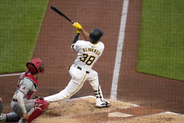 Pittsburgh Pirates' Edward Olivares (38) follows through on a grand slam off Los Angeles Angels starting pitcher Tyler Anderson during the third inning of a baseball game in Pittsburgh, Monday, May 6, 2024. (AP Photo/Gene J. Puskar)