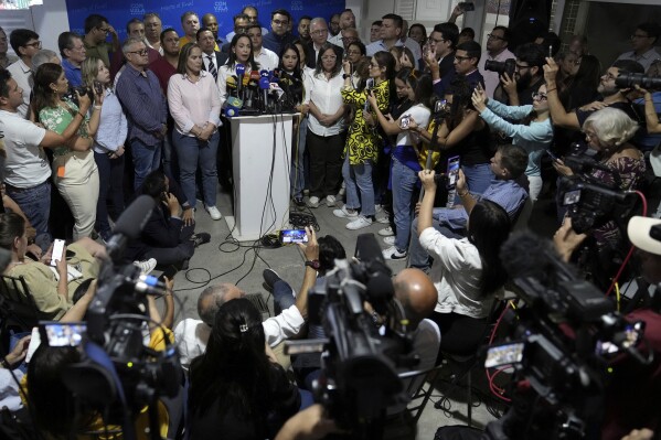 Opposition leader María Corina Machado speaks at a press conference regarding the arrest order for her campaign manager and eight other opposition members for alleged involvement in a conspiracy plot to destabilize the government, in Caracas, Venezuela, Wednesday, March 20, 2024. Machado has been disqualified from holding public office for 15 years but has continued to campaign for president ahead of the July 28 elections. (AP Photo/Ariana Cubillos)