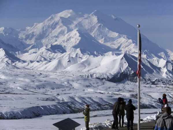 People stand at the Eielson Visitor Center with a view of North America's tallest peak, Denali, in the background, Sept. 2, 2015, in Denali National Park and Preserve, Alaska. (AP Photo/Becky Bohrer, file)