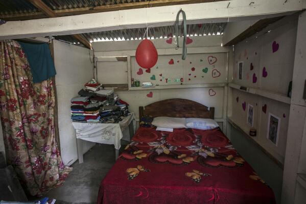 The interior of the one-room home of a young woman, who said she went through her abortion here alone the previous year by taking pills, stands in an unidentified mountainous area of western Honduras, Sunday, March 19, 2023. With a cellphone as her only companion for chats with a friend and an anonymous guide, the then 27-year-old became one of the women who are terminating pregnancies across the country with the help of clandestine networks. (AP Photo/Ginnette Riquelme)