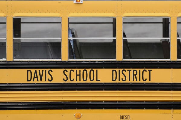 A Davis School District bus sits at the Bus Farm in Farmington, Utah, in this undated photo. A Black woman hired by the northern Utah school district to investigate racial harassment complaints a year after a 10-year-old Black student died by suicide says that she, too, experienced discrimination from district officials. Joscelin Thomas, a former coordinator in the Davis School District's equal opportunity office, alleges in a federal lawsuit that district administrators treated her “as if she were stupid," accused her of having a substandard work ethic and denied her training and mentorship opportunities that were offered to her white colleagues. (Matt Gade/The Deseret News via AP, file)