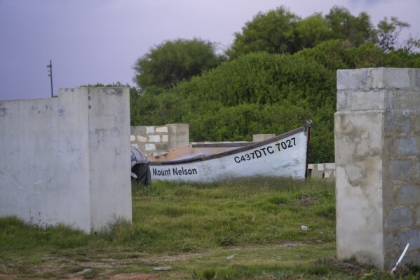 A fishing boat rests in a courtyard in the seaside village of Hawston, South Africa, April 27, 2023. (AP Photo/Jerome Delay)