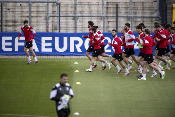 Players warm up during a training session of Georgia's national soccer team in Velbert, Germany, Thursday, June 13, 2024. (Fabian Strauch/dpa via AP)