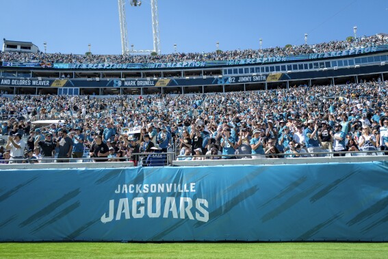 FILE - Jacksonville Jaguars fans cheer during an NFL football game at EverBank Stadium, Sunday, Oct. 15, 2023, in Jacksonville, Fla. The Jaguars and the city of Jacksonville have agreed to a $1.4 billion “stadium of the future” that would keep the franchise in one of the NFL's smallest markets for another 30 years. The plan was presented at a city council meeting Tuesday., May 14, 2024. (AP Photo/Alex Menendez, File)