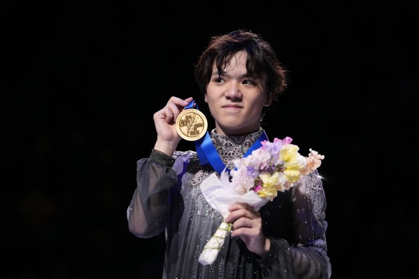FILE - Shoma Uno of Japan shows off his gold medal after winning the men's free skating in the World Figure Skating Championships in Saitama, north of Tokyo, on March 25, 2023. Olympic medalist and two-time world champion Uno said Thursday, May 9, 2024, he is retiring. (Ǻ Photo/Hiro Komae, File)