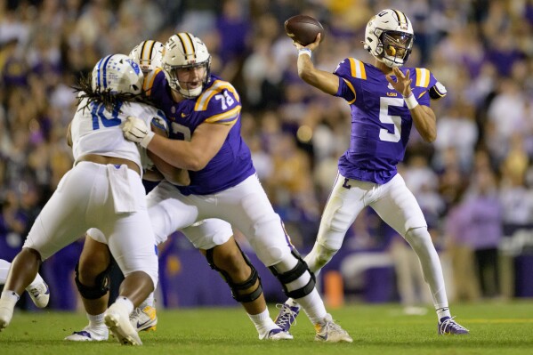 LSU quarterback Jayden Daniels (5) throws during the first half of an NCAA college football game against Georgia State in Baton Rouge, La., Saturday, Nov. 18, 2023. (AP Photo/Matthew Hinton)