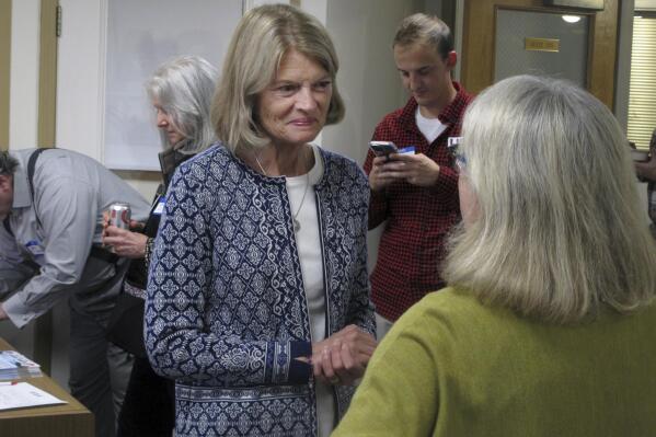 Alaska U.S. Sen. Lisa Murkowski, center, is shown at the grand opening of her reelection campaign office in Juneau, Alaska, on Thursday, Aug. 11, 2022. Murkowski said she expects to be among the candidates who will advance from the Aug. 16, 2022, U.S. Senate primary in Alaska. Under a system approved by voters and being used in Alaska for the first time this year, the top four vote-getters in the primary, regardless of party affiliation, will advance to the November general election, in which ranked voting will be used. (AP Photo/Becky Bohrer)