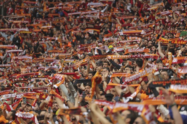 Galatasaray fans cheer during a Turkish Super Lig soccer match between Galatasaray and Fenerbahce in Istanbul, Turkey, Sunday, May 19, 2024. (AP Photo)