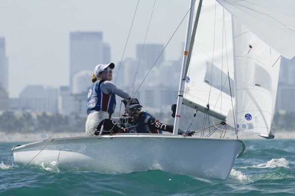 Stu McNay, right, and Lara Dallman-Weiss campaign in the mixed-gender 470 category at U.S. Sailing Olympic Trials, off the coast of Miami Beach, Fla., Friday, Jan. 12, 2024. McNay is returning for his fifth Olympics and teaming up with Dallman-Weiss, who competed in the women's 470 in the Tokyo Games, in the new mixed-gender category. (AP Photo/Rebecca Blackwell)