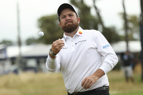 Shane Lowry of Ireland throws his ball into the stands as he walks from the 18th green following his second round of the British Open Golf Championships at Royal Troon golf club in Troon, Scotland, Friday, July 19, 2024. (ĢӰԺ Photo/Scott Heppell)