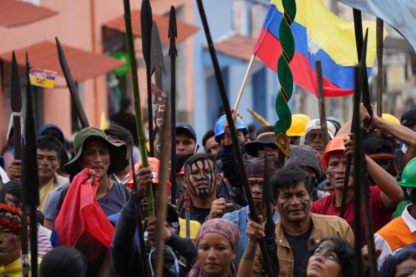 Indigenous protesters march to the Basilica del Voto Nacional where they expect dialogue with the government to take place in downtown Quito, Ecuador, Monday, June 27, 2022. Ecuadorian President Guillermo Lasso announced a cut in gasoline prices Sunday that fell short of the reduction demanded by Indigenous leaders to end a strike that has paralyzed parts of the country for two weeks. (AP Photo/Dolores Ochoa)