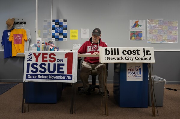 Michael Bond, treasurer of the Licking County Democratic Party, works at the front desk, ready to pass out signs for "Vote Yes on Issue 1" and "Bill Cost Jr. for Newark City Council," at the Licking County Democratic Party headquarters in Newark, Ohio, Tuesday, Oct. 31, 2023. (AP Photo/Carolyn Kaster)