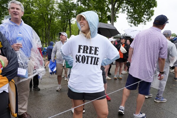 Emily Ferrando wears a T-shirt she bought in the parking lot in support of Scottie Scheffler during the second round of the PGA Championship golf tournament at the Valhalla Golf Club, Friday, May 17, 2024, in Louisville, Ky. (AP Photo/Matt York)