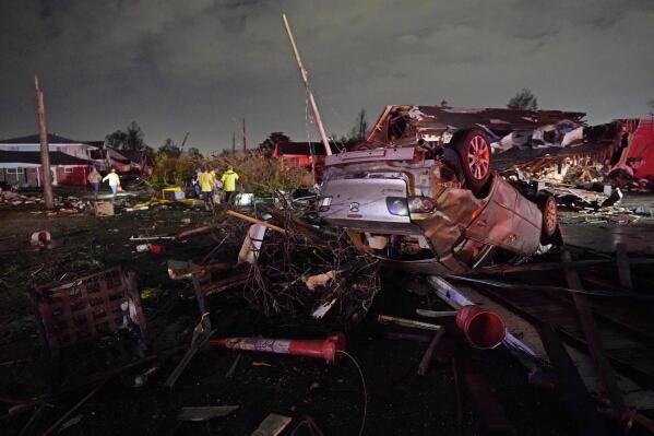 FILE - A car is flipped over after a tornado tore through the area in Arabi, La., Tuesday, March 22, 2022, in a part of the city that had been heavily damaged by Hurricane Katrina 17 years earlier. A United Nations report released on Monday, April 25, 2022, says disasters are on the rise are just going to get worse. A new UN report says the number of disasters, from climate change to COVID-19, are going to jump to about 560 a year by 2030. (AP Photo/Gerald Herbert, File)