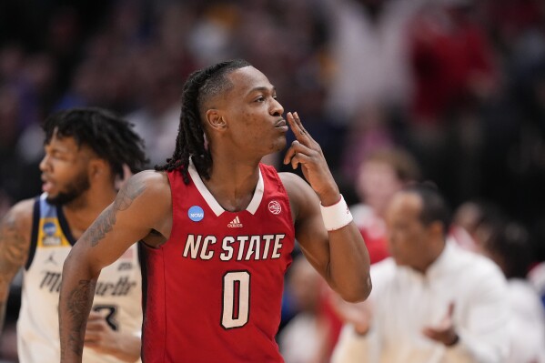 North Carolina State's DJ Horne reacts after scoring a basket against Marquette during the second half of a Sweet 16 college basketball game in the NCAA Tournament in Dallas, Friday, March 29, 2024. (AP Photo/Tony Gutierrez)
