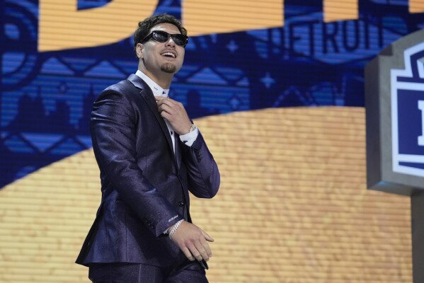 UCLA defensive lineman Laiatu Latu walks on stage during the first round of the NFL football draft, Thursday, April 25, 2024, in Detroit. (AP Photo/Jeff Roberson)